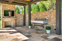 The pool pergola features a ShadeFX, all-weather retractable roof system. Additionally, the pergola features a wood-burning fireplace and an antique sink sourced from a farmhouse in Tuscany.