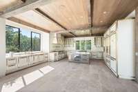 The kitchen is outfitted with double ovens, two dishwashers, two trash receptacles, drink drawers, wine cooler, ice maker, and motorized fridge/freezer.