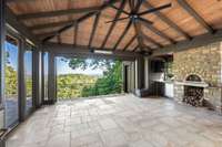 You’ll enjoy a wood fired pizza oven, DCS gas grill and rotisserie, and drink drawers in your summer kitchen. The screens on the far side of the patio are retractable.