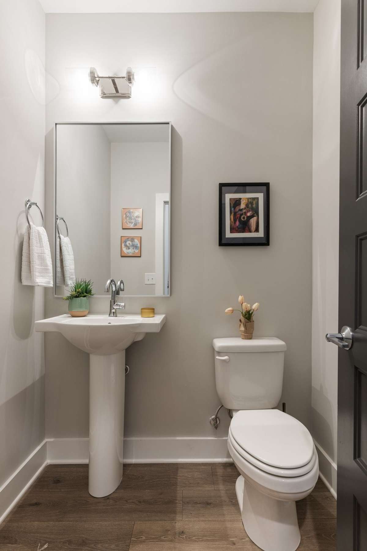 The half bathroom is located conveniently between the living room and kitchen.