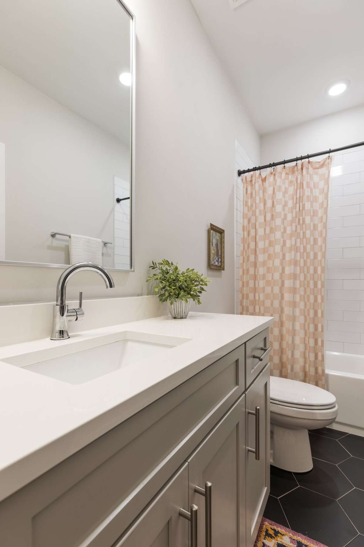 The second full bathroom located off of this second bedroom. Lots of counter space as well as a tub/shower combo.