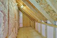 Unfinished storage room located off primary bedrooms closet. . . the perfect places to hide Christmas presents