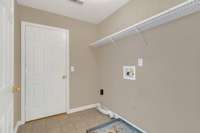 Upstairs laundry room.  Door leads to unfinished storage room.