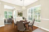 Kitchen dining area Virtually Staged. . .  with sunroom in the back.