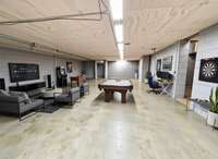 Lots of added potential for recreation and hobby space in THIS large Conditioned Basement. Virtually Staged Photo for Inspiration Only and to Showcase How Space Can Be Used and Furnished.