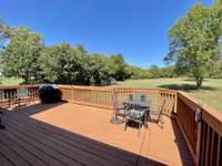 Enjoy breaking bread on your spacious back deck, taking in serene views of the expansive and spectacular backyard.