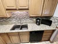 Double under-mount composite sink with stylish pullout faucet.