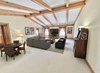 Perfect for large gatherings, this oversized great room features a vaulted ceiling, creating an open and inviting space for family and friends. Virtually Staged Photo for Inspiration Only and to Showcase How Space Can Be Used and Furnished.