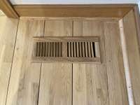 Elegant wide-plank flooring with custom wood vents provides a sophisticated, tailored touch.