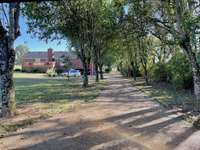 Set back from the road, the long, sweeping driveway offers exceptional privacy and ample parking for gatherings.