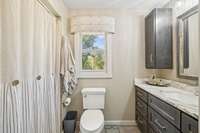 Renovated master with updated vanity and countertops.