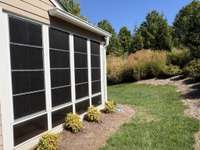 Screen porch with plastic windows.