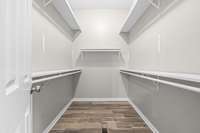 Primary bedroom walk in closet