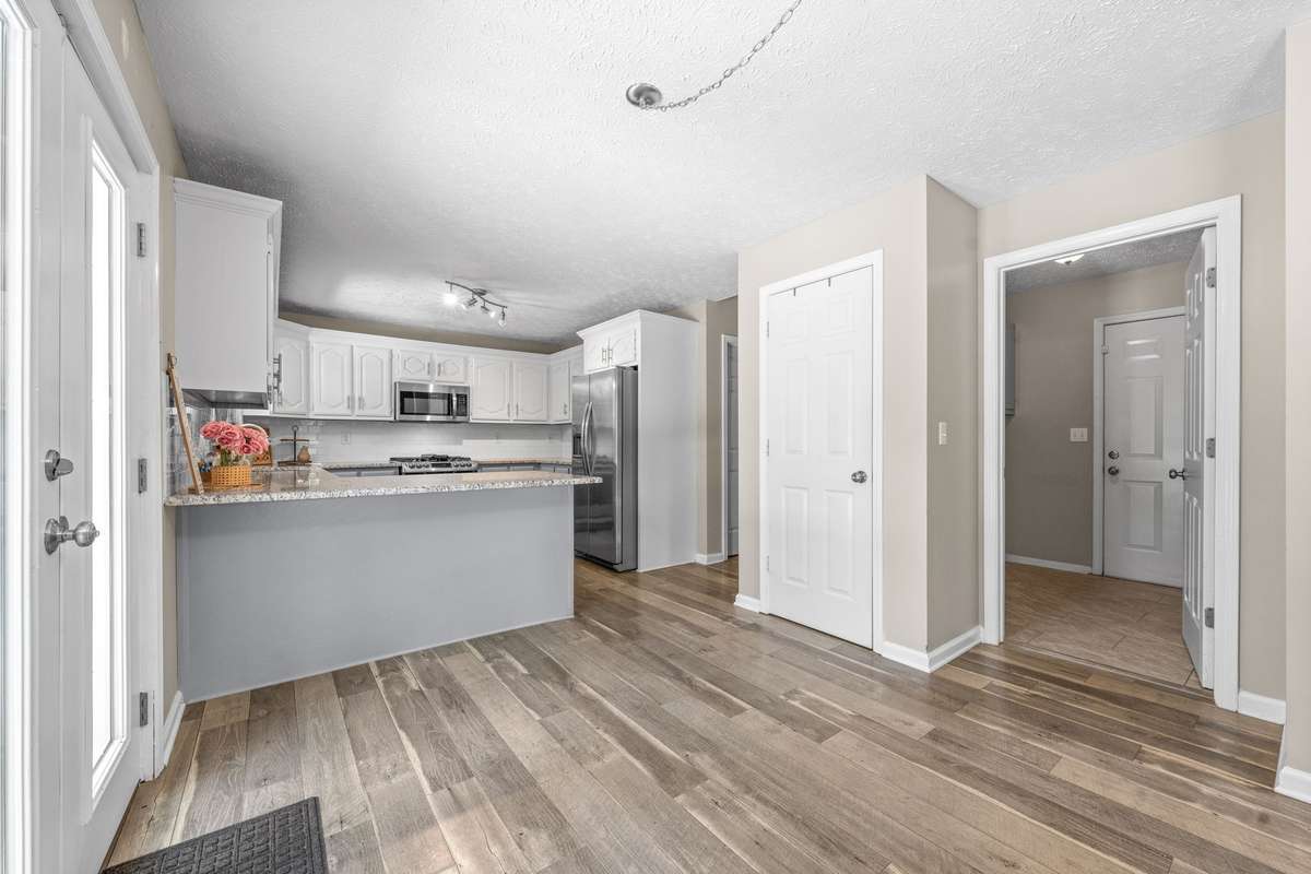 Kitchen with pantry, and laundry room to the side with garage entrance