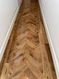 Real hardwood with a herringbone pattern in the entry foyer