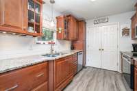 Bright kitchen with updated backsplash and high quality cabinets, appliances updated as well