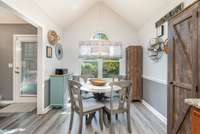 Enjoy these high ceiling and custom blinds in the eat in kitchen