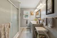 Primary bath has a single vanity sink and large walk in shower.  564 Hodges Road Smithville, TN 37166