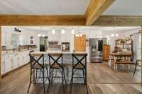 Entering the kitchen is an island with a bar and modern hanging over head lighting.  564 Hodges Road Smithville, TN 37166