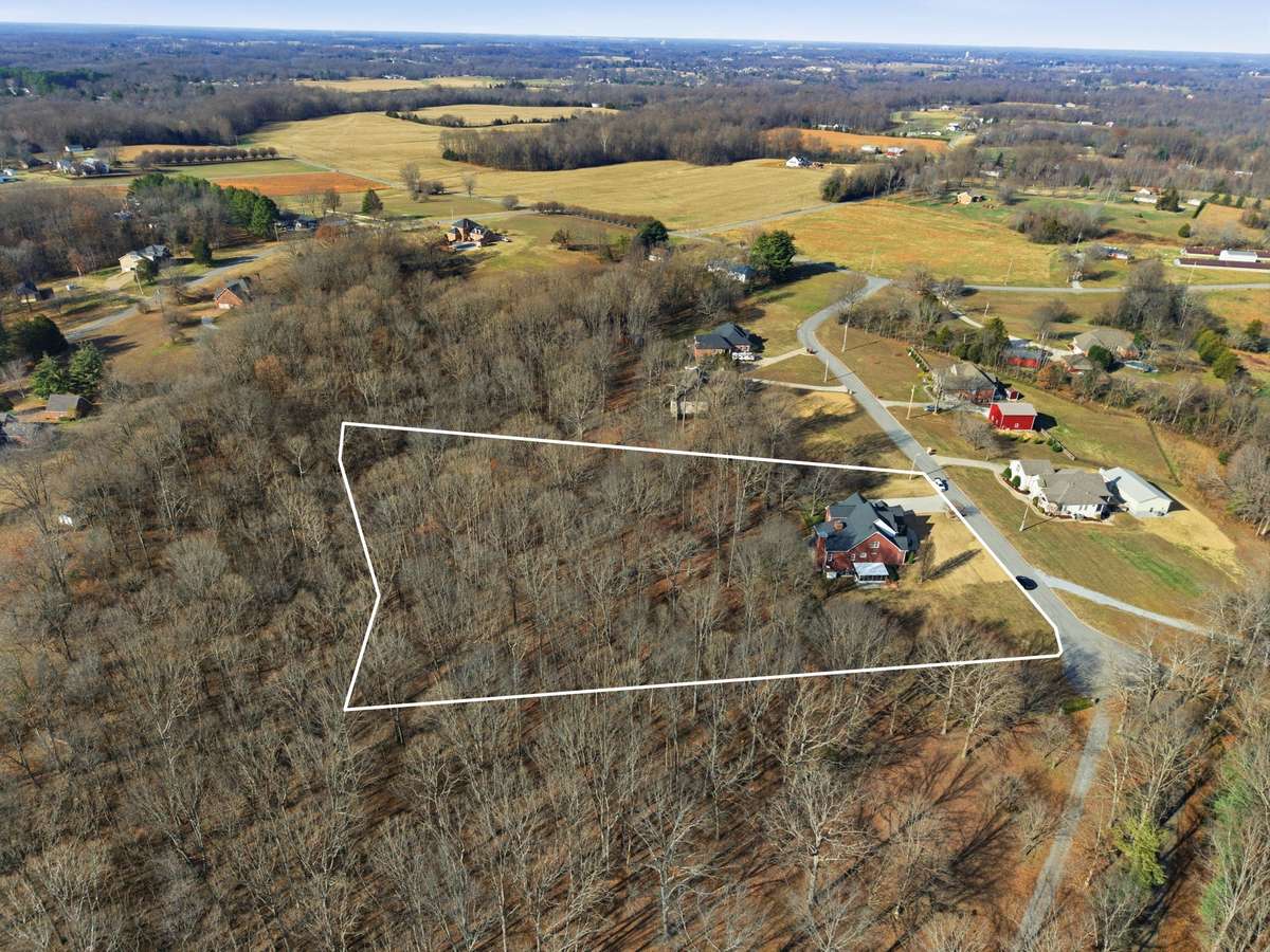 Aerial view of this stately all-brick home nestled on 4.01 acres, surrounded by mature trees for privacy and peaceful country-style living just minutes from town.Aerial view of this stately all-brick home nestled on 4.01 acres, surrounded by mature t