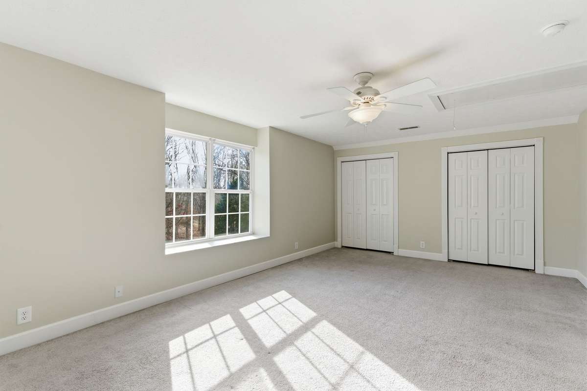 Spacious Bedroom #2 on one end of upper hallway, double closets and views of property!
