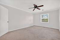 Peaceful top-floor bedroom with soft natural light and fresh paint throughout.