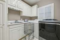 Laundry room with plenty of storage.
