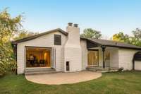 The back patio and outdoor fireplace extend the living space, creating a perfect setting for gatherings or quiet evenings at home.