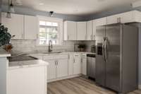 Bright, modern kitchen with stainless steel appliances and ample cabinet space.