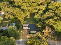 Bird’s-eye view showcasing the spacious backyard and surrounding landscape of West Meade.