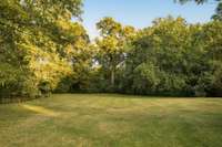 Massive backyard provides endless space for outdoor living and play.