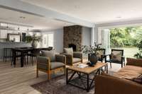 The fireplace serves as a stunning focal point, seamlessly connecting the living room, kitchen, and dining area.