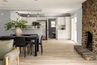 A beautiful working stone fireplace adds warmth and timeless character to the space.