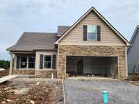 House Features Decorative Stacked Stone on the Front Porch and around the Garage Door. 
Picture of Previous House.