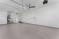 Garage with epoxy flooring and sink.