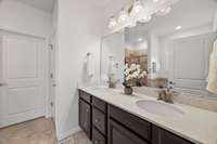 The large ensuite bathroom is beautifully appointed with double vanities, a relaxing separate soaking tub and a stand-up shower.