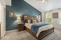 The primary bedroom offers a versatile layout that accommodates any bed size, while vaulted ceilings enhance the sense of space and comfort