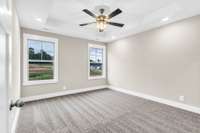 Spacious primary bedroom featuring a luxurious en-suite with dual vanities and a large walk-in closet—offering both comfort and functionality.