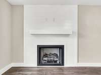 Cozy gas fireplace with shiplap surround and modern mantle—creates a stylish focal point in the living room.