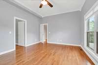 Large windows, hardwood floors, crown molding