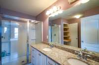 Granite, double vanity, and notice the built-in, pull-out shelves in the linen closet. This condo is loaded with extras.
