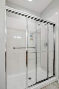 Shower upgrade includes cultured marble wall panels.