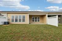 Covered back patio with nice level back yard.