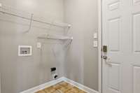 This is the laundry room near the garage and kitchen area.