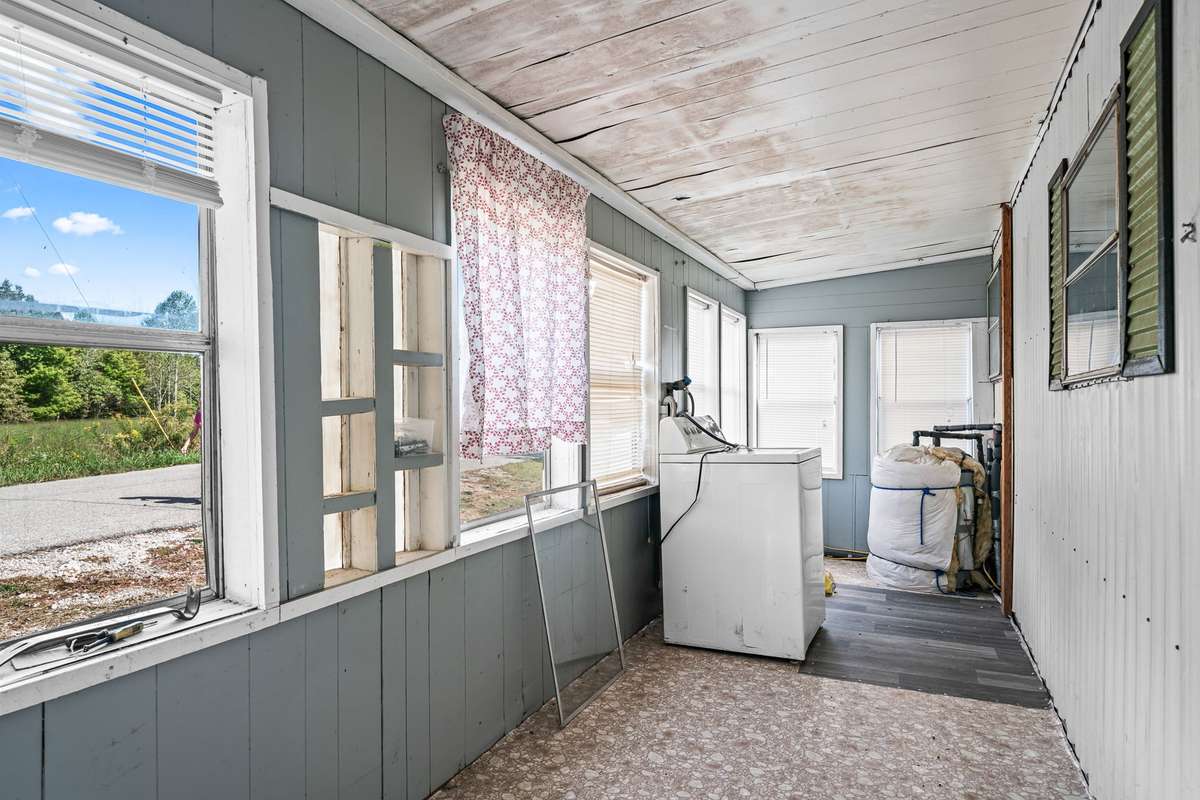 Front inclosed covered porch with also laundry hookups