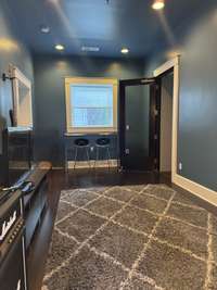 Actual alternate photo of this space to the main door on the left and the door to the studio space on the right.  Behind us is the half bath easily converted to a full bath with shower.