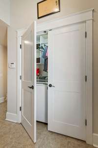 Sneak peek into the laundry space.  Shelves and hanging space too!