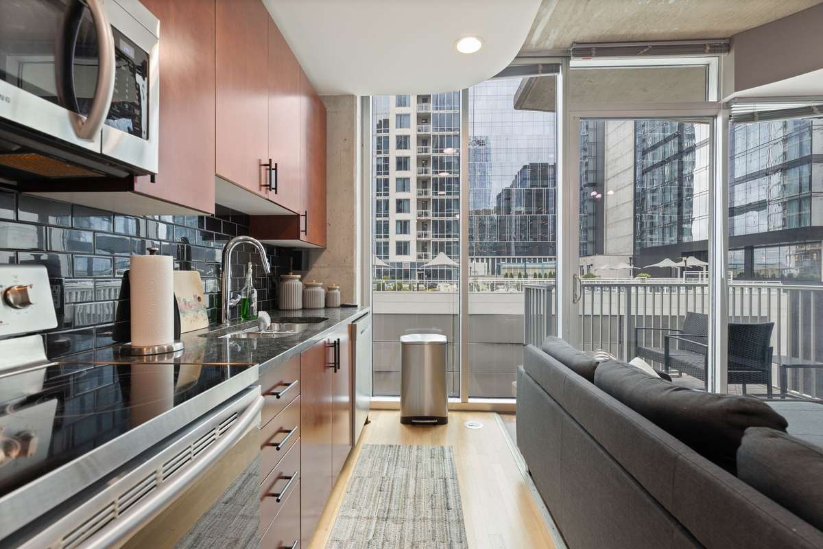 Kitchen has granite counters and subway tile backsplash