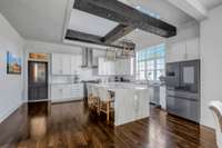 immaculate countertops throughout including the waterfall island featuring the open ceiling.