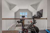 Landing at the top of the stairs currently used as a small gym area